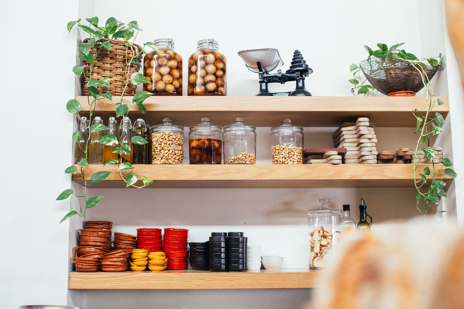 Les bocaux, conserves et biscuits rangés sur les étagères en bois de l'épicerie fine